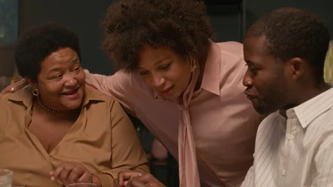 Black Woman Having Fun while Chatting with Family Celebrating Holiday at Home Stockbeeldmateriaal 304587091