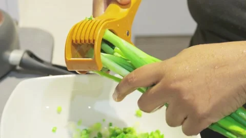 Black woman quickly chops fresh green scallions close up Stock Footage 346674322