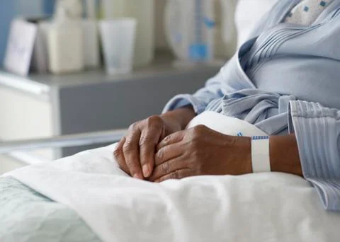 Black woman recovering in hospital bed Stock Photos