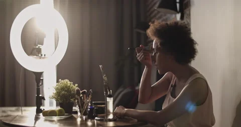 Black woman shooting makeup tutorial Stock Footage 214988144