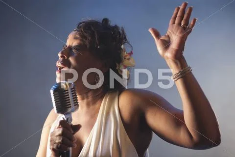 Black Woman Singing Into Microphone