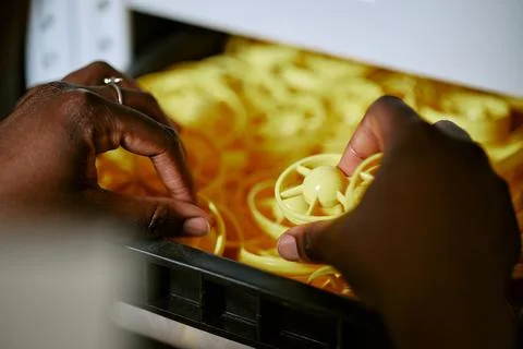 Black Woman Sorting Plastic Components in Factory Storage Stock Photos