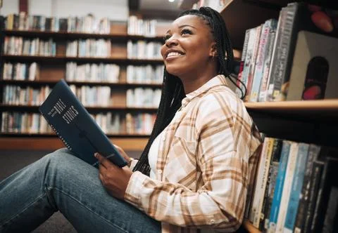 Black woman student, reading or library floor for religion, study or bible in Stock Photos