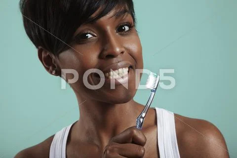 Black woman with a teethh brush Stock Photos