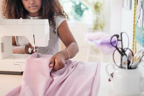 Black woman using sewing machine Stock Photos