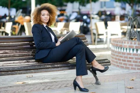 Black woman using tablet computer in town Stock Photos