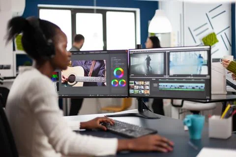 Black woman videographer developing project film montage Stock Photos