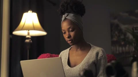 Black woman work remotely sitting at chair in home interior.Young afro girl Stock Footage 236334904
