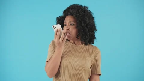 Black woman yelling while talking on the phone. Angry African American girl Video stock 240135535