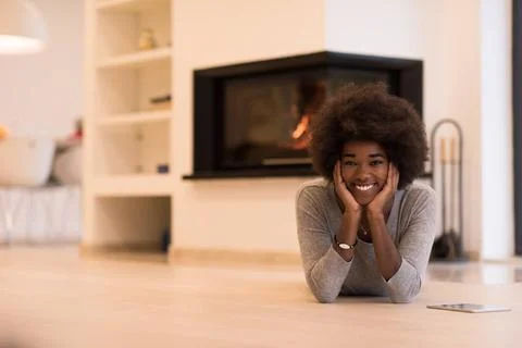 Black women using tablet computer on the floor beautiful young black women... Stock Photos