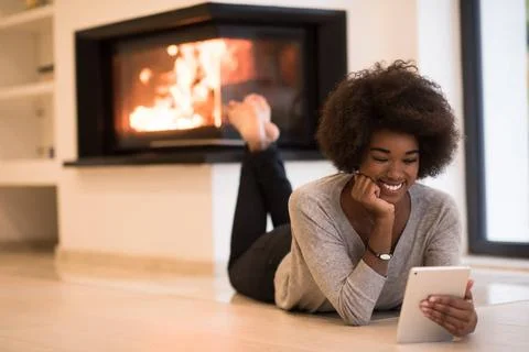 Black women using tablet computer on the floor beautiful young black women... Stock Photos