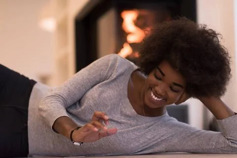 Black women using tablet computer on the floor beautiful young black women... Stock Photos