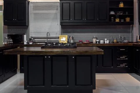 Black wood kitchen with touches of white brick Stock Photos