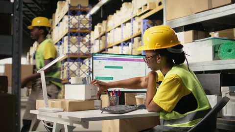 Black worker applying and scanning barcodes awb tags on cargo boxes Stock Footage 315543251