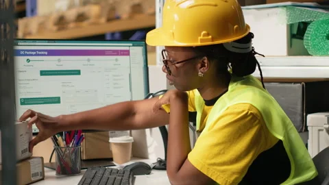 Black worker applying and scanning barcodes awb tags on cargo boxes Stock Footage 315714116