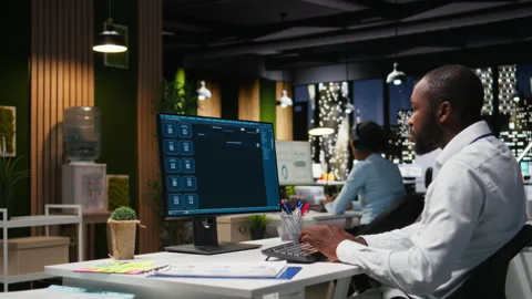 Black worker uses AI chatbot system at desktop for problem solving tasks Stock Footage 318499981