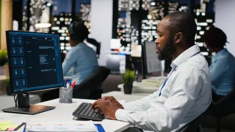 Black worker uses AI chatbot system at desktop for problem solving tasks Stock Photos