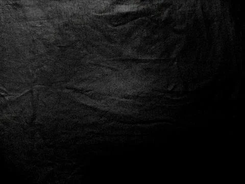 Black wrinkled fabric texture with dramatic folds and intricate weave in mo.. Stock Photos