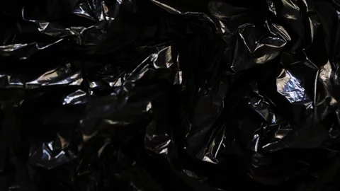 Black wrinkled used plastic texture background. Stop motion Stock Footage 279844805