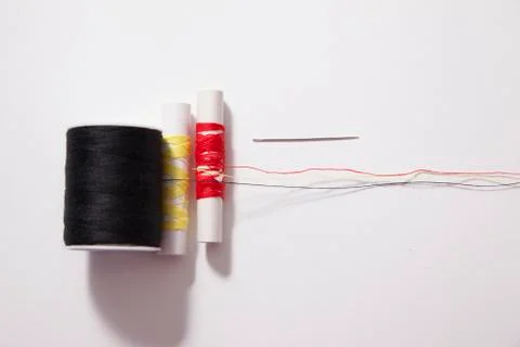 Black, yellow and red thread and needle Stock Photos