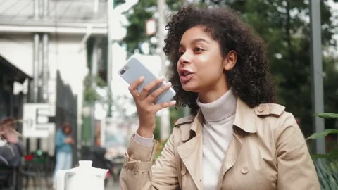 Black young girl using smart phone voice recognition, dictates thoughts, voice Stock Footage 142809787