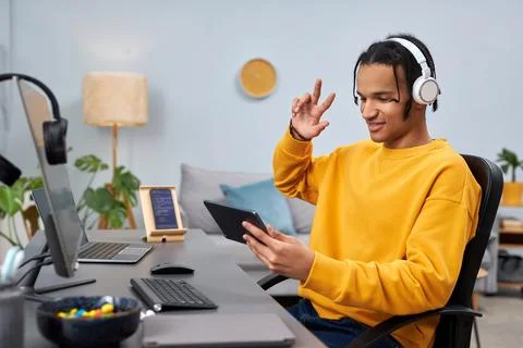 Black young man as software developer using digital tablet at workplace 스톡 사진