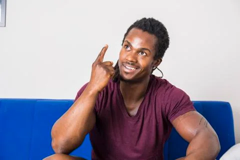 Black young man thinking an idea, doing funny expression Stock Photos