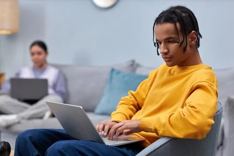 Black young man using laptop and working 库存照片