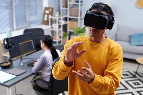 Black young man using VR in IT development office Stock Photos