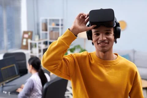 Black young man using VR and smiling at camera Stock Photos