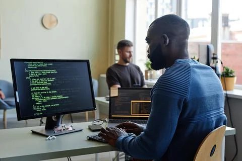 Black Young Man Writing Code Foto stock