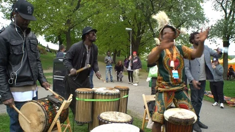 Black young people dancing, singing and playing drums in a City Park Stock Footage 76205262