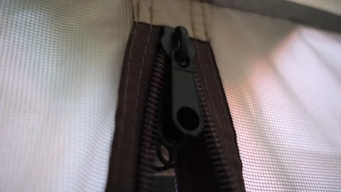 Black zipper with a large double slider at the entrance to a light tent Stock Footage 247080395