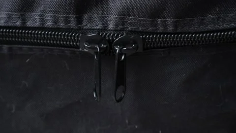Black Zipper Pulls Swaying on Black Fabric Stock Footage 195961535