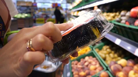 Blackberries in a package in the hands of a customer. Stock-Footage 287176048