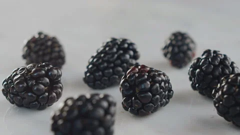 On blackberries sprinkle dried apricots on top in slow motion 120 Stock Footage 101680416