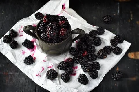 Blackberries on white napkin in rustic setting Stock Photos