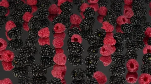 Blackberry and raspberry with reflection on black background. Side view Stock Footage 237858312