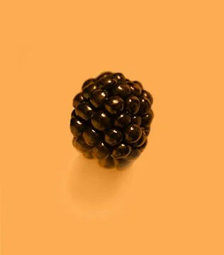 Blackberry on an orange background Stock Photos