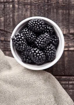 Blackberry in white bowl  on grunge wooden board. Natural healthy food.Still Stock Photos