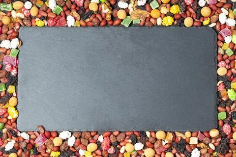 Blackboard on the background of a frame of nuts and dried fruits Stock Photos