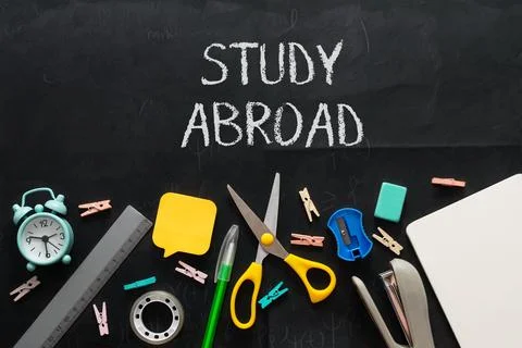 A blackboard with a chalkboard message that says Study Abroad Stock Photos