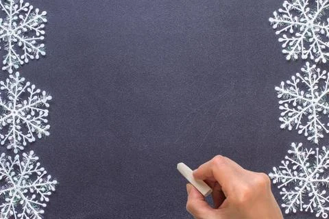 Blackboard with a hand starting to write Stock Photos