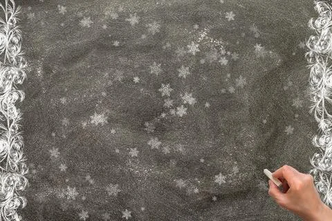 Blackboard with a hand starting to write. Stock Photos