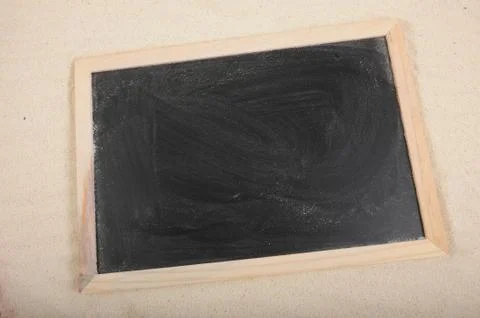 Blackboard on sand Stock Photos