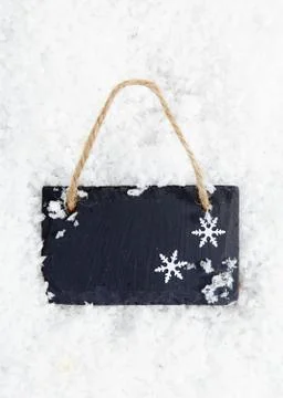 Blackboard on snow with snowflakes Stock Photos