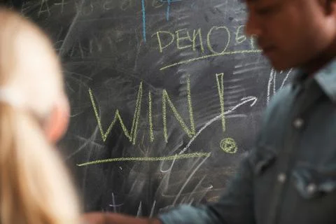 Blackboard with word win written on it 写真素材