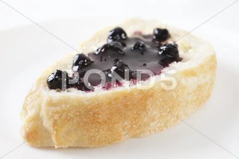 Blackcurrant jam on bread Stock Photos