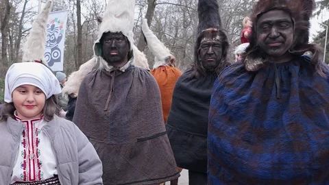 Blackfaced Kukeri masquerade perfromers pose at Balkan winter festival Stock Footage 304508408
