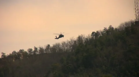 Blackhawk over mountain Stock Footage 1102653